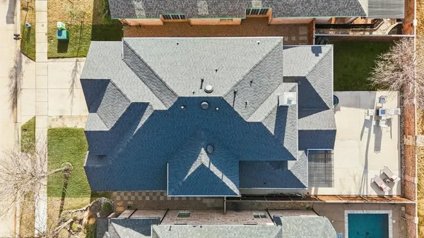 an aerial view of a house with a yard