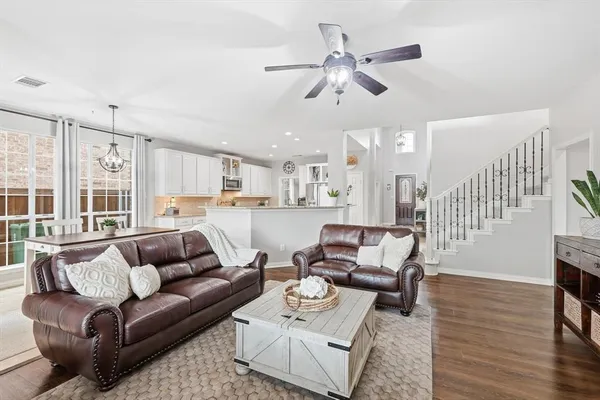 a living room with furniture and kitchen view
