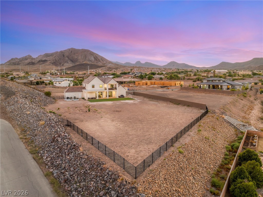 324 Wanda Road Henderson, NV 89002 - Photo 88 of 96 Dramatic mountain backdrops frame a spacious residential property featuring a large fenced lot.