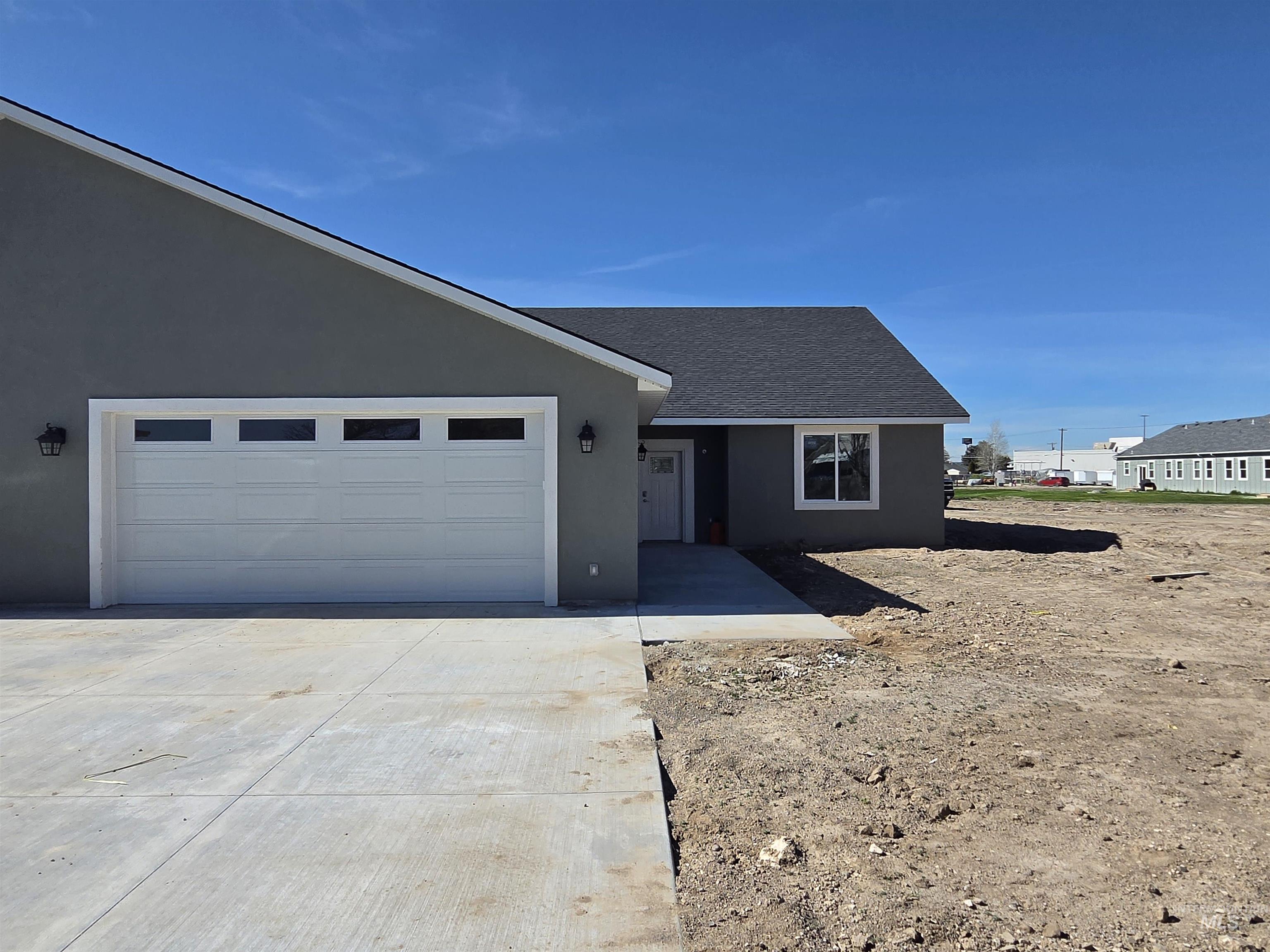 40 Lakeside Loop Burley, ID 83318 - Photo 1 of 15 Ranch-style home featuring stucco siding, roof with shingles, driveway, and a garage
