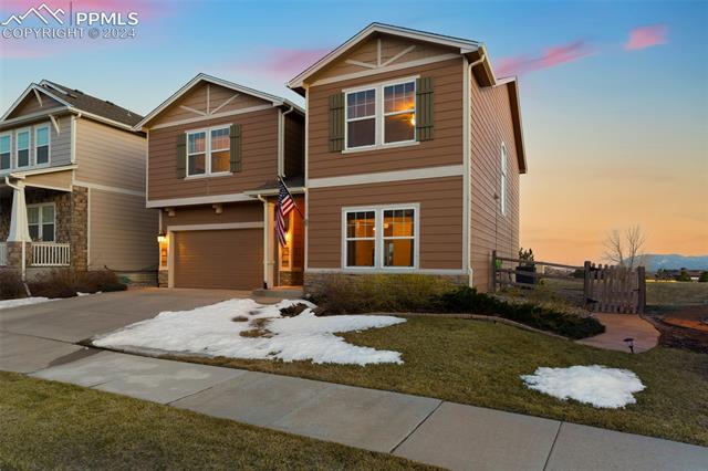 835 Diamond Rim Drive Colorado Springs, CO 80921 - Photo 6 of 7 View of front of property featuring a yard and a garage