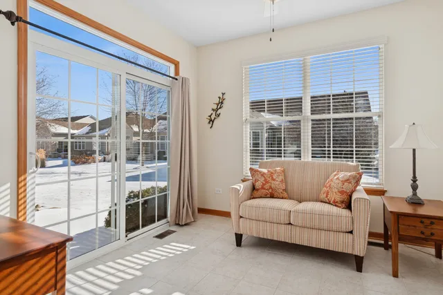 a living room with furniture windows and wooden floor