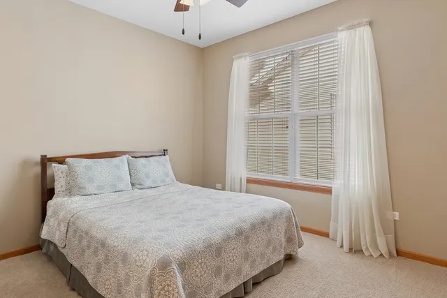 a large bed sitting in a bedroom next to a window
