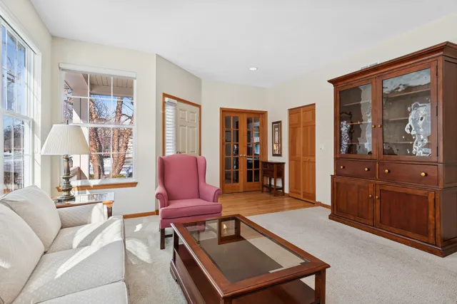 a room with pool table and windows