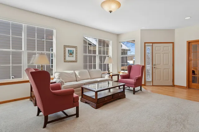 a living room with furniture a rug and a book shelf
