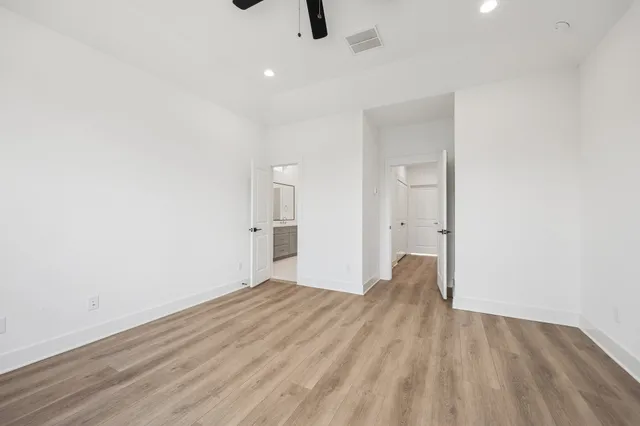 a view of empty room with wooden floor