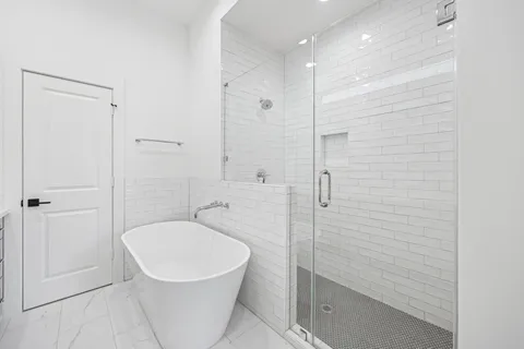 a bathroom with a toilet a sink and shower