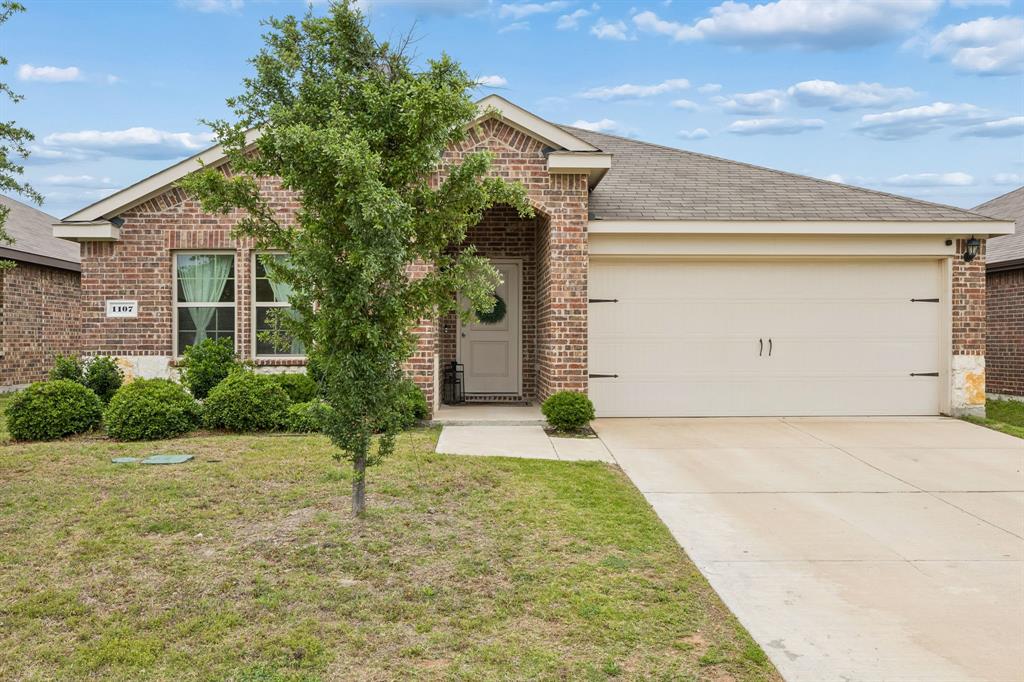 1107 Ringgold Road Forney, TX 75126 - Photo 10 of 27 Brick exterior featuring a covered entry and an attached two-car garage
