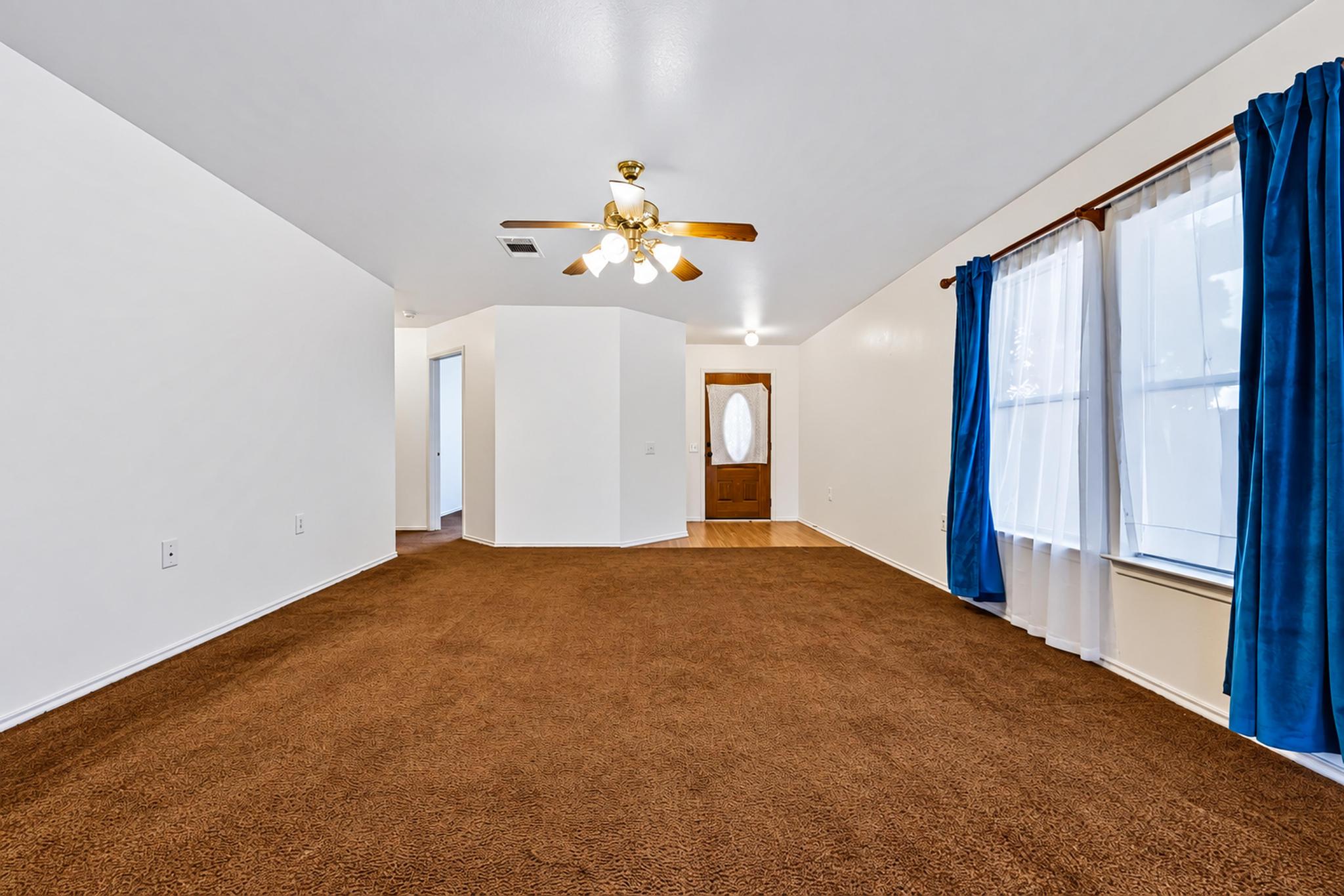 7317 Marble Ridge Drive Austin, TX 78747 - Photo 9 of 30 Warm plush carpeting pairs with abundant natural light streaming through large front windows.