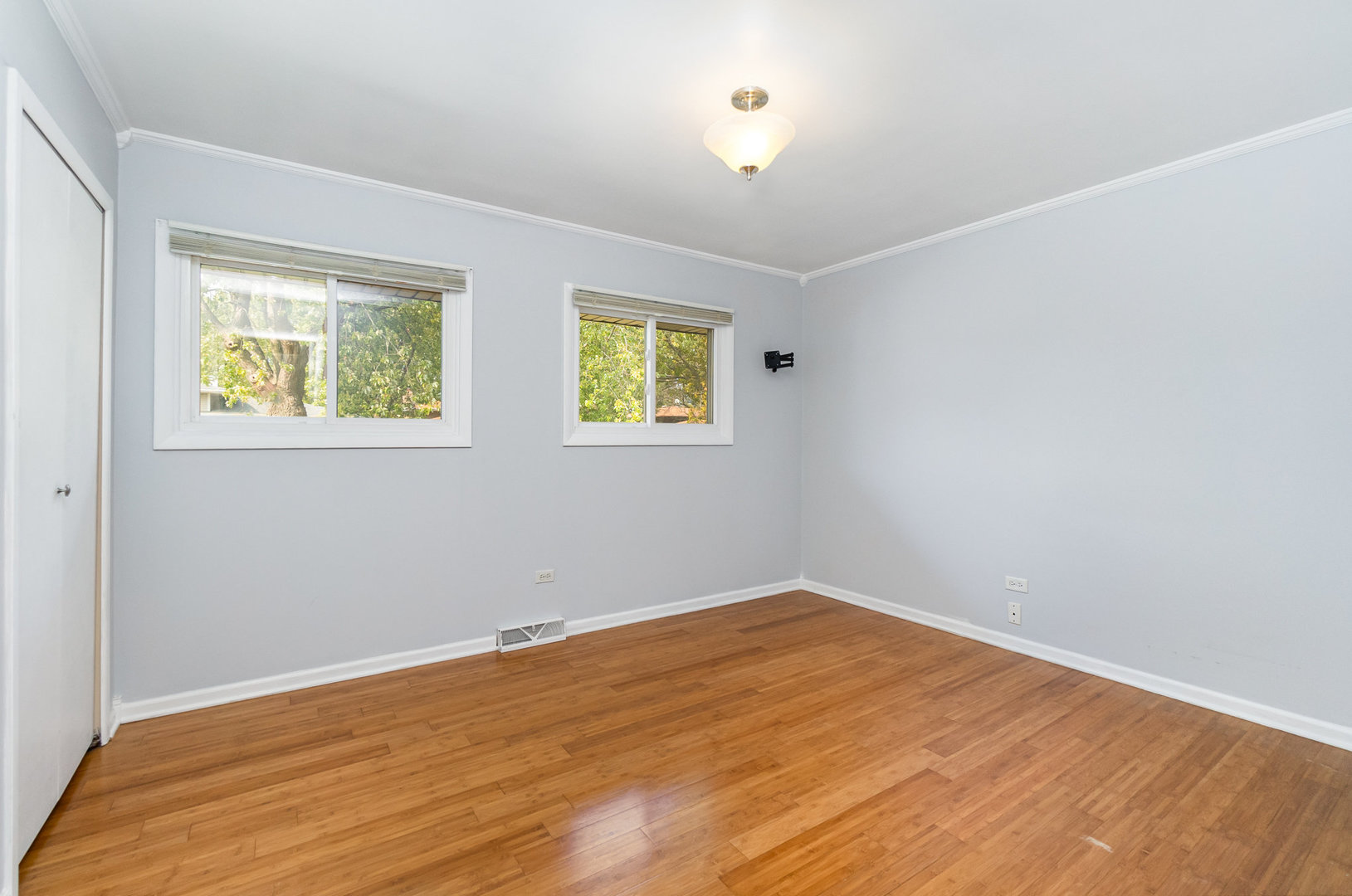 2831 193rd Street Lansing, IL 60438 - Photo 14 of 28 a view of an empty room with wooden floor and a window