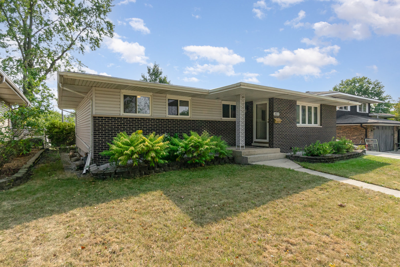 2831 193rd Street Lansing, IL 60438 - Photo 2 of 28 a front view of a house with garden
