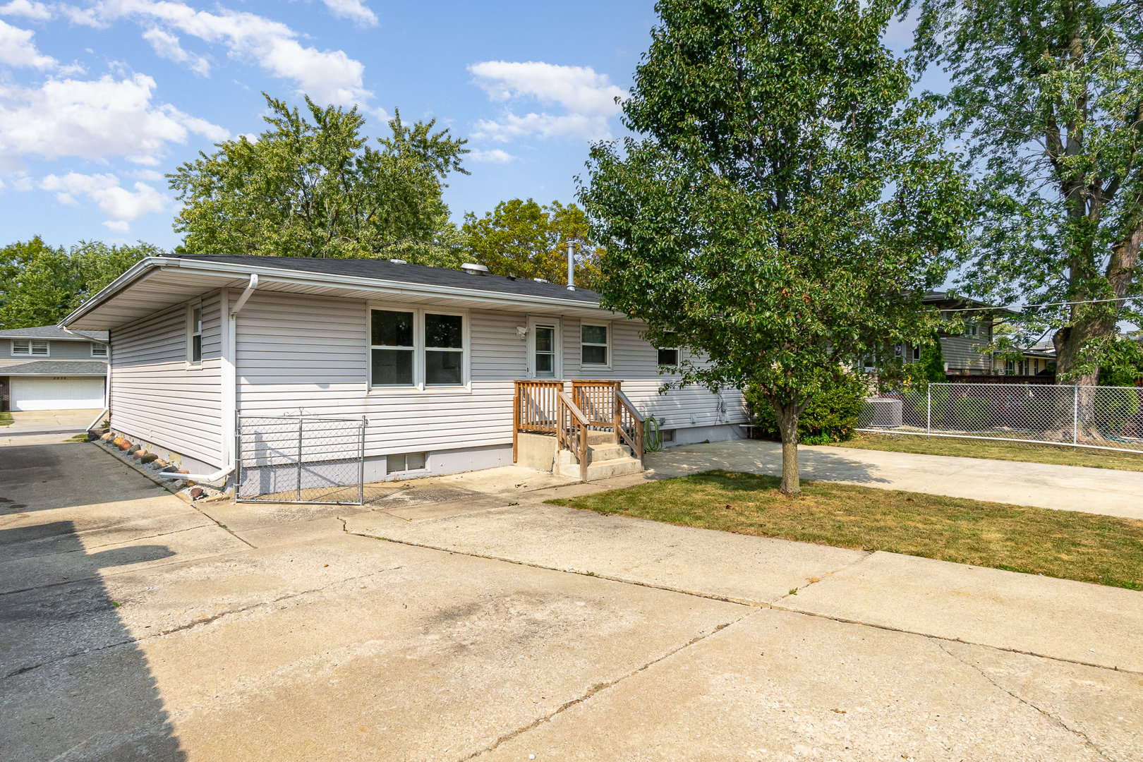 2831 193rd Street Lansing, IL 60438 - Photo 23 of 28 a view of a house with backyard and trees