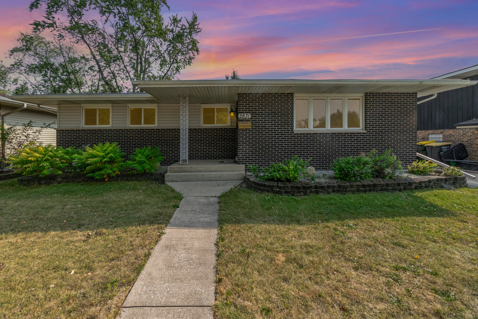 2831 193rd Street Lansing, IL 60438 - Photo 26 of 28 a backyard of a house with lots of green space and plants