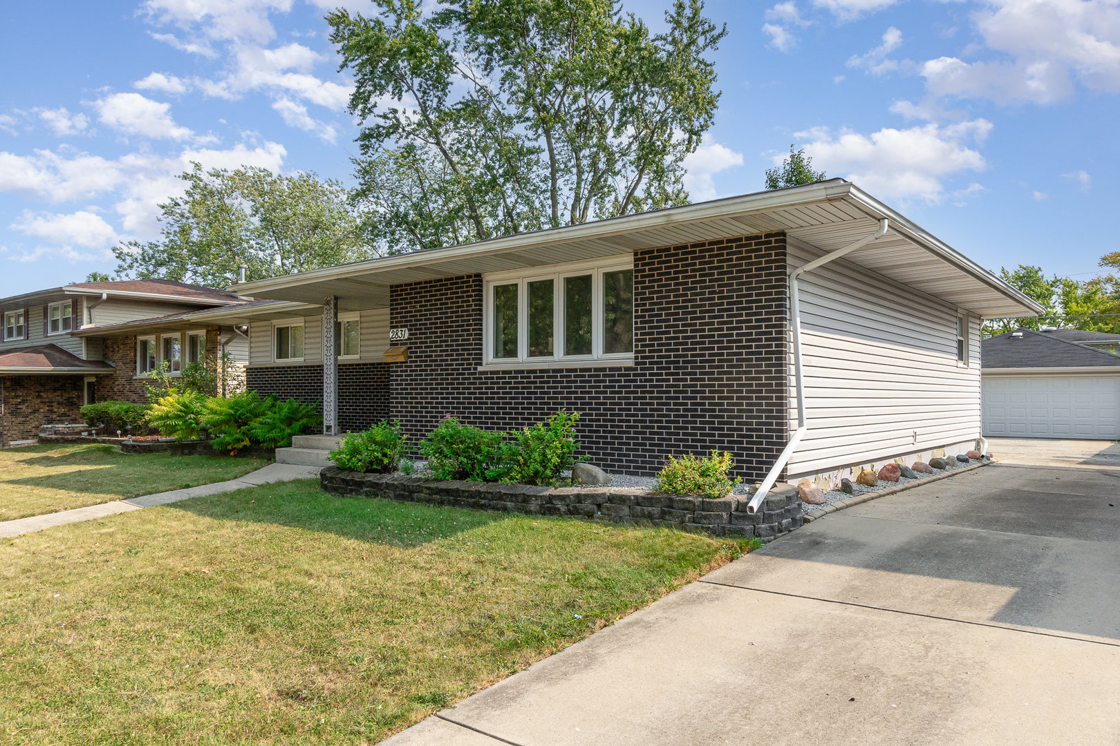 2831 193rd Street Lansing, IL 60438 - Photo 3 of 28 a front view of a house with garden