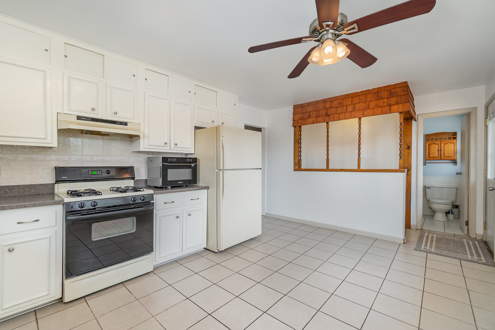2831 193rd Street Lansing, IL 60438 - Photo 8 of 28 a kitchen with a stove cabinets and a refrigerator