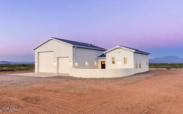 a view of a house with a backyard