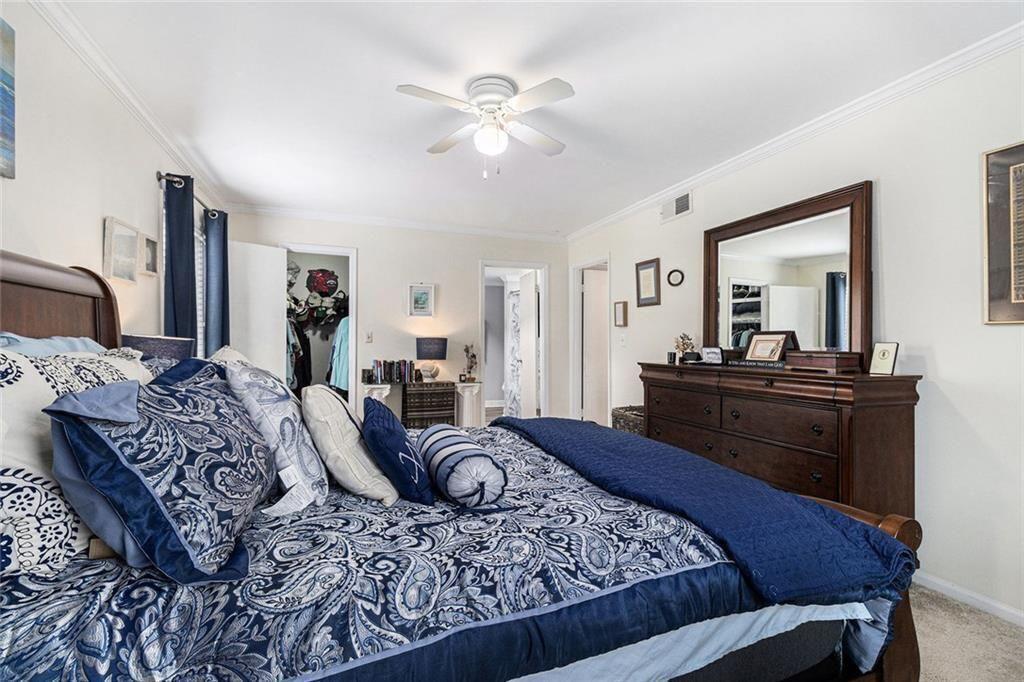 6851 Roswell Road, Unit M5 Atlanta, GA 30328 - Photo 13 of 21 a bedroom with a large bed and a dresser