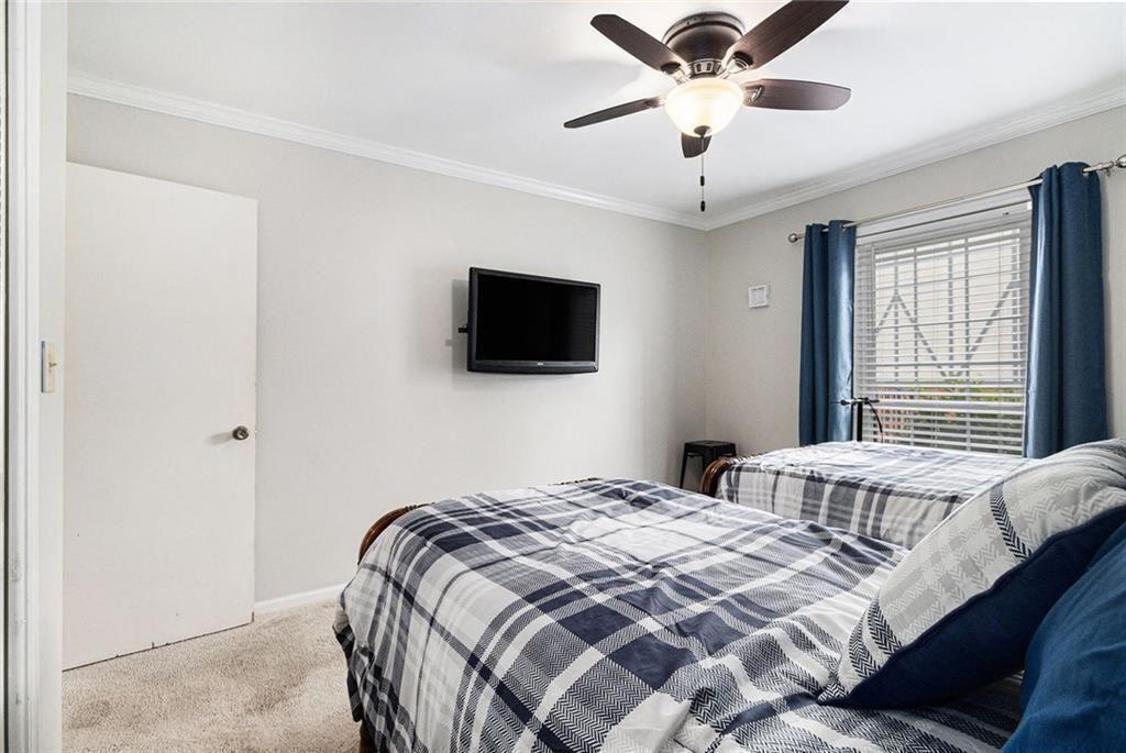 6851 Roswell Road, Unit M5 Atlanta, GA 30328 - Photo 16 of 21 a bedroom with bed and tv