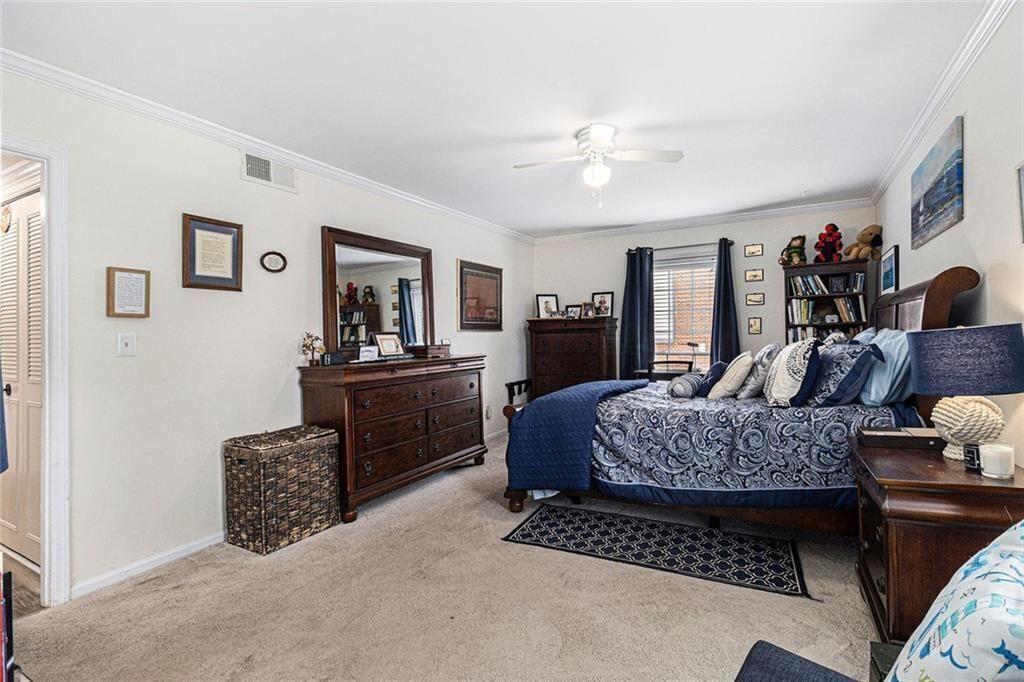 6851 Roswell Road, Unit M5 Atlanta, GA 30328 - Photo 10 of 21 a living room with furniture and a chandelier