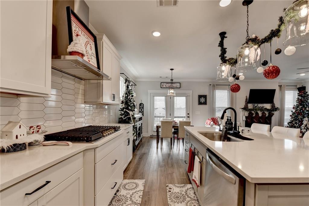 572 Redfish Way Hoschton, GA 30548 - Photo 11 of 67 a kitchen with a sink stove and cabinets