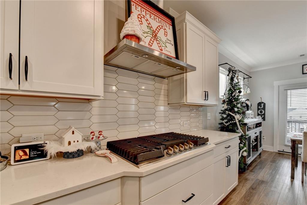 572 Redfish Way Hoschton, GA 30548 - Photo 12 of 67 a kitchen with a stove and cabinets