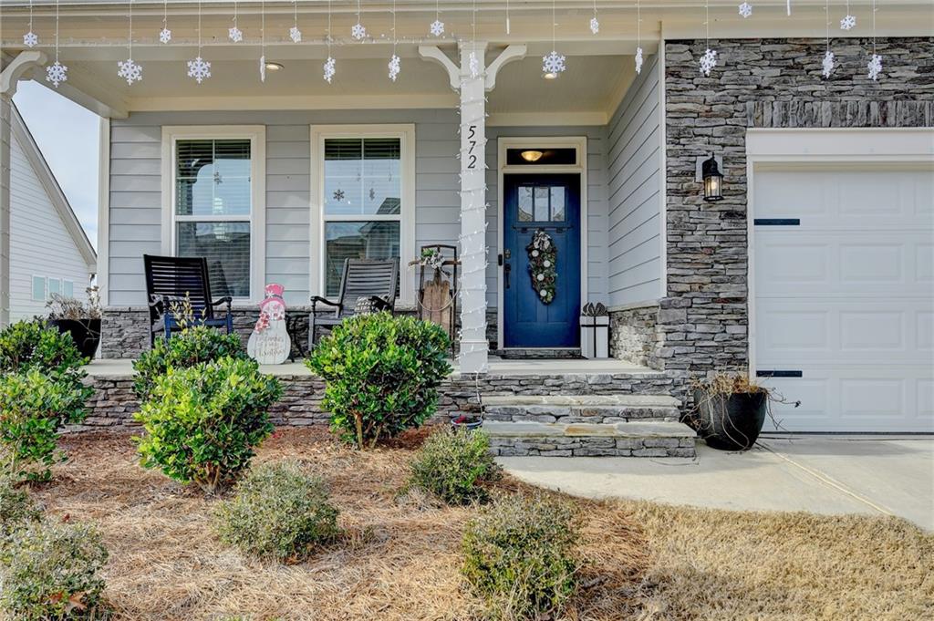 572 Redfish Way Hoschton, GA 30548 - Photo 2 of 67 a view of a building with potted plants