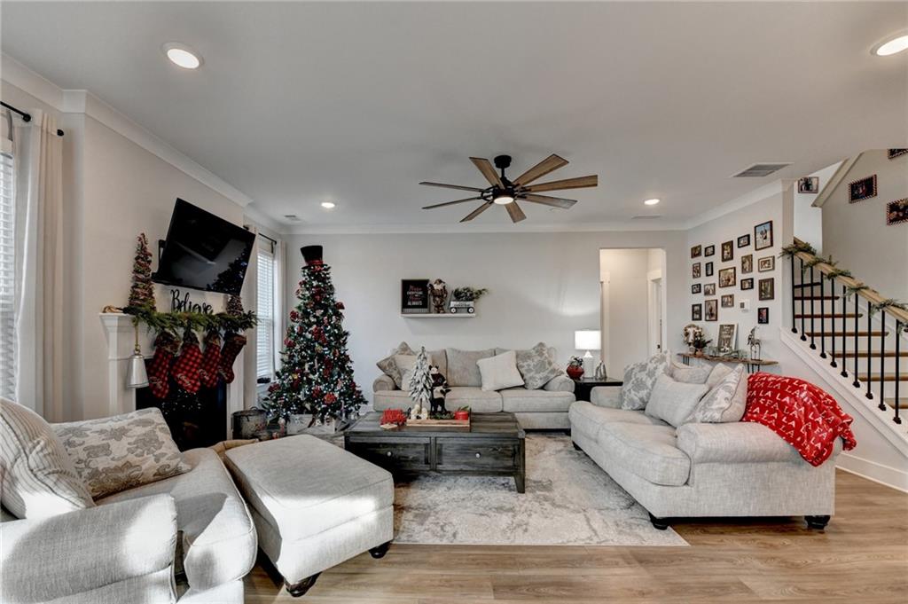 572 Redfish Way Hoschton, GA 30548 - Photo 22 of 67 a living room with furniture and a flat screen tv
