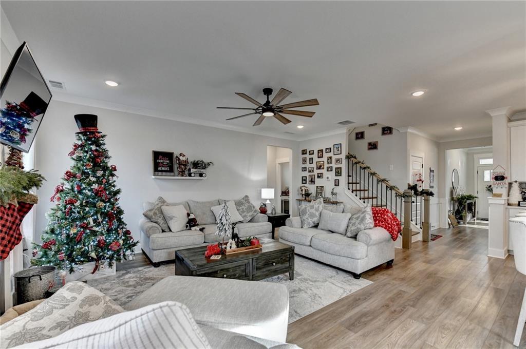 572 Redfish Way Hoschton, GA 30548 - Photo 23 of 67 a living room with furniture and a potted plant