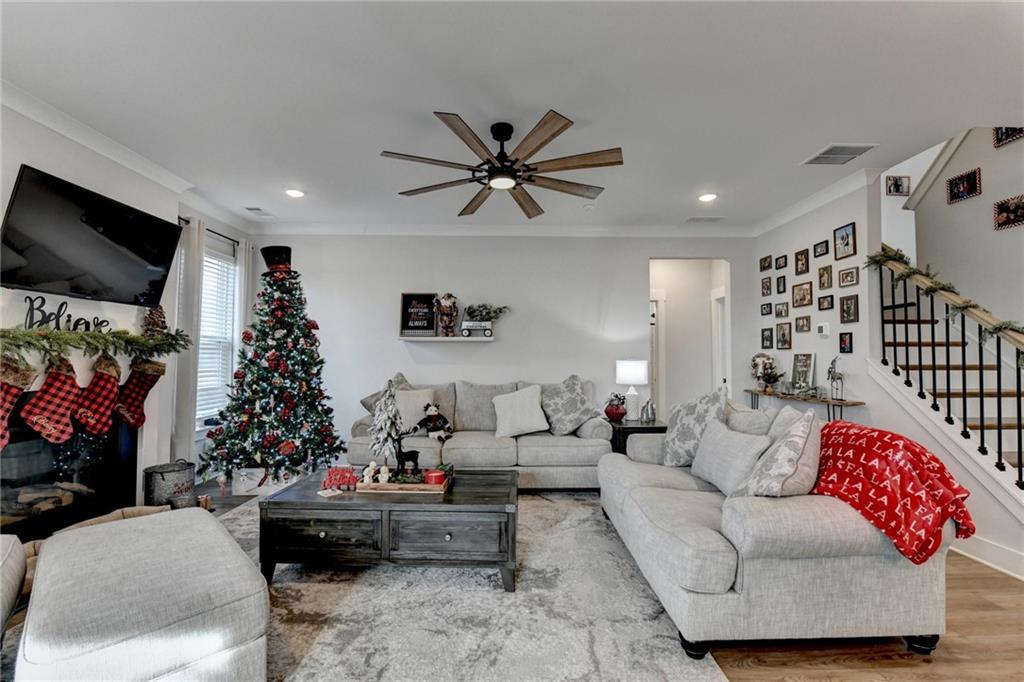 572 Redfish Way Hoschton, GA 30548 - Photo 24 of 67 a living room with furniture gym equipment and a window