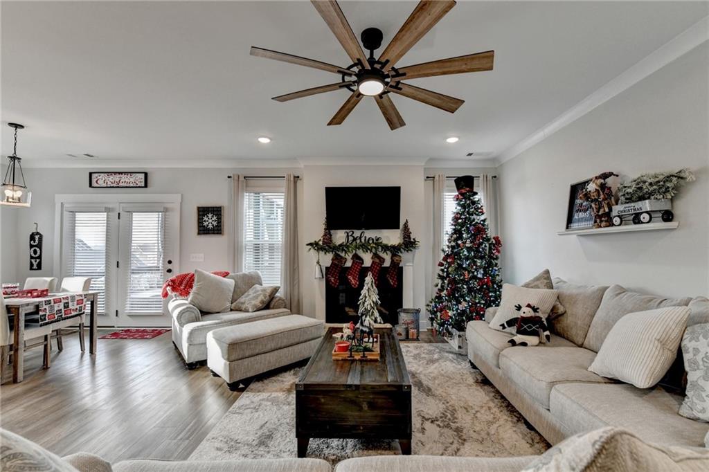 572 Redfish Way Hoschton, GA 30548 - Photo 25 of 67 a living room with furniture and a flat screen tv