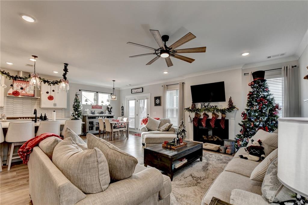 572 Redfish Way Hoschton, GA 30548 - Photo 26 of 67 a living room with furniture and a flat screen tv