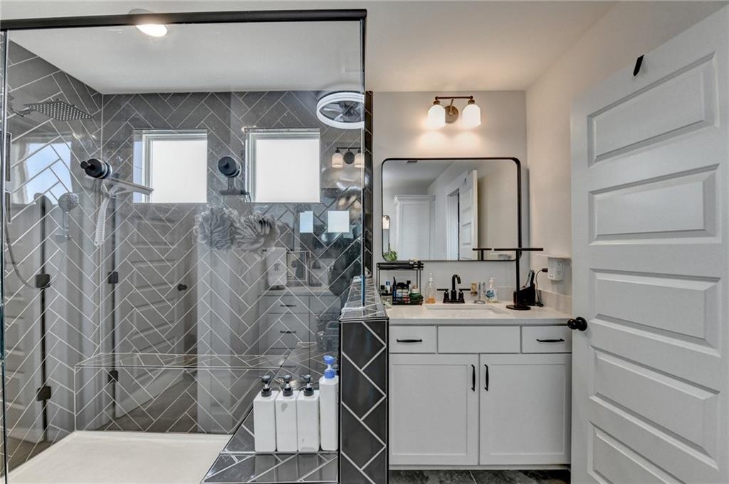 572 Redfish Way Hoschton, GA 30548 - Photo 34 of 67 a bathroom with a sink a toilet and mirror