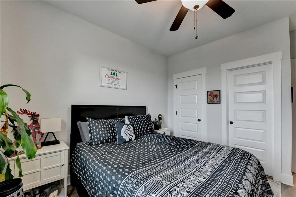 572 Redfish Way Hoschton, GA 30548 - Photo 38 of 67 a bedroom with a bed and a potted plant