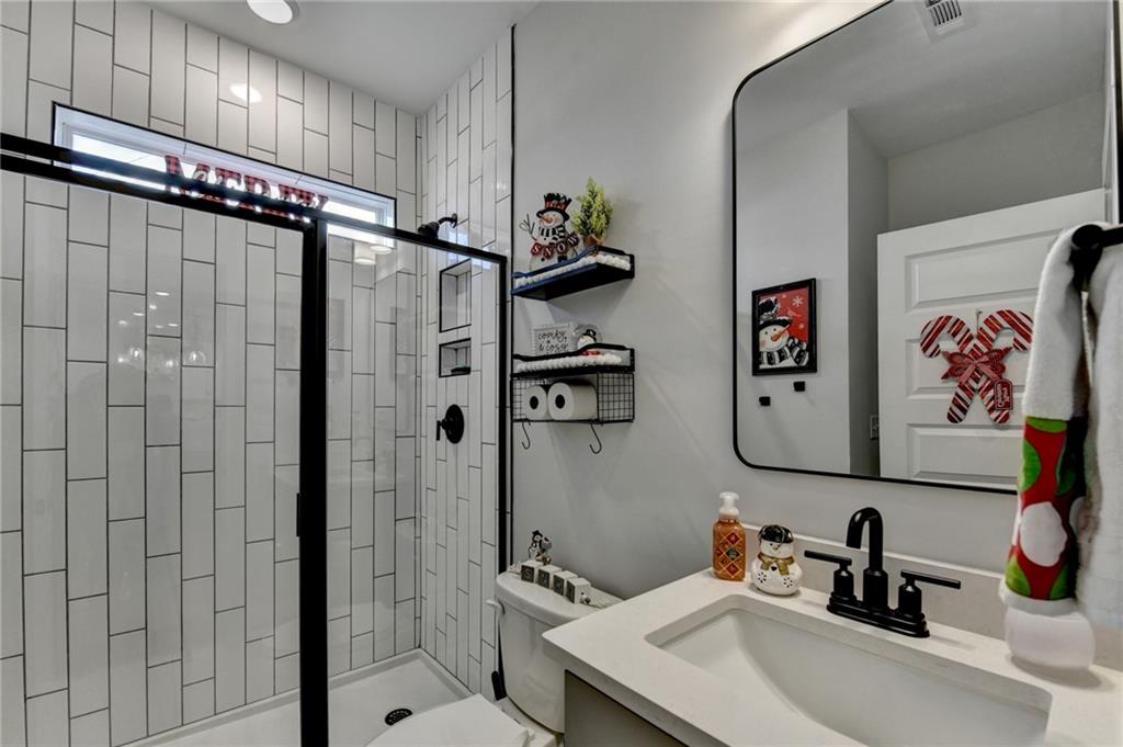 572 Redfish Way Hoschton, GA 30548 - Photo 39 of 67 a bathroom with a sink and mirror