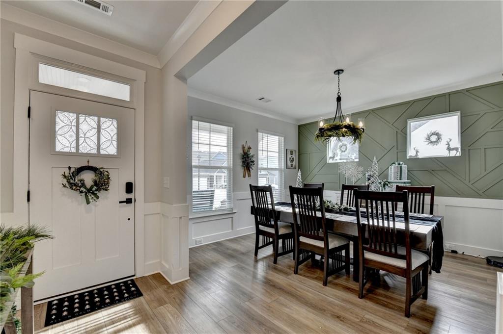572 Redfish Way Hoschton, GA 30548 - Photo 4 of 67 a view of a dining room with furniture window and wooden floor