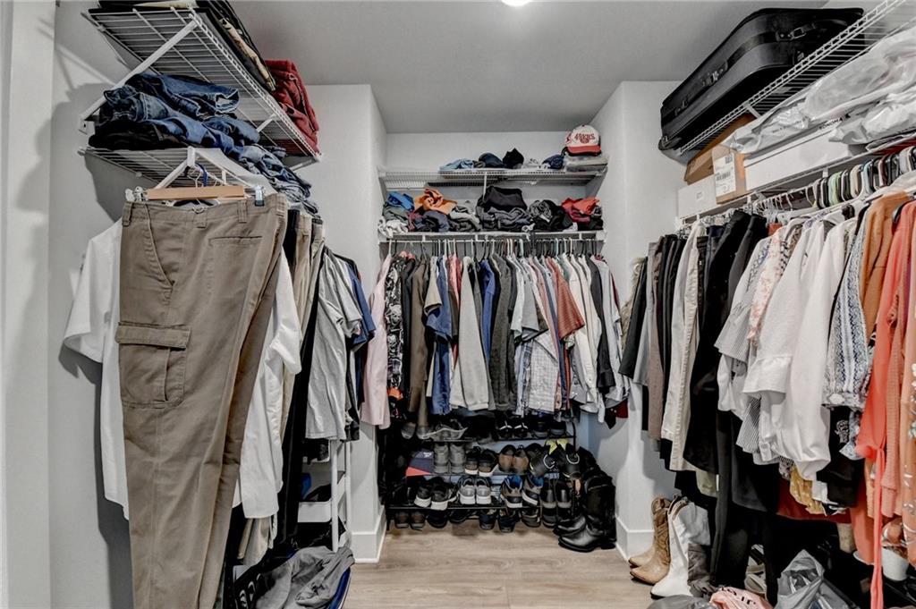 572 Redfish Way Hoschton, GA 30548 - Photo 42 of 67 a view of walk in closet with clothes and shoes