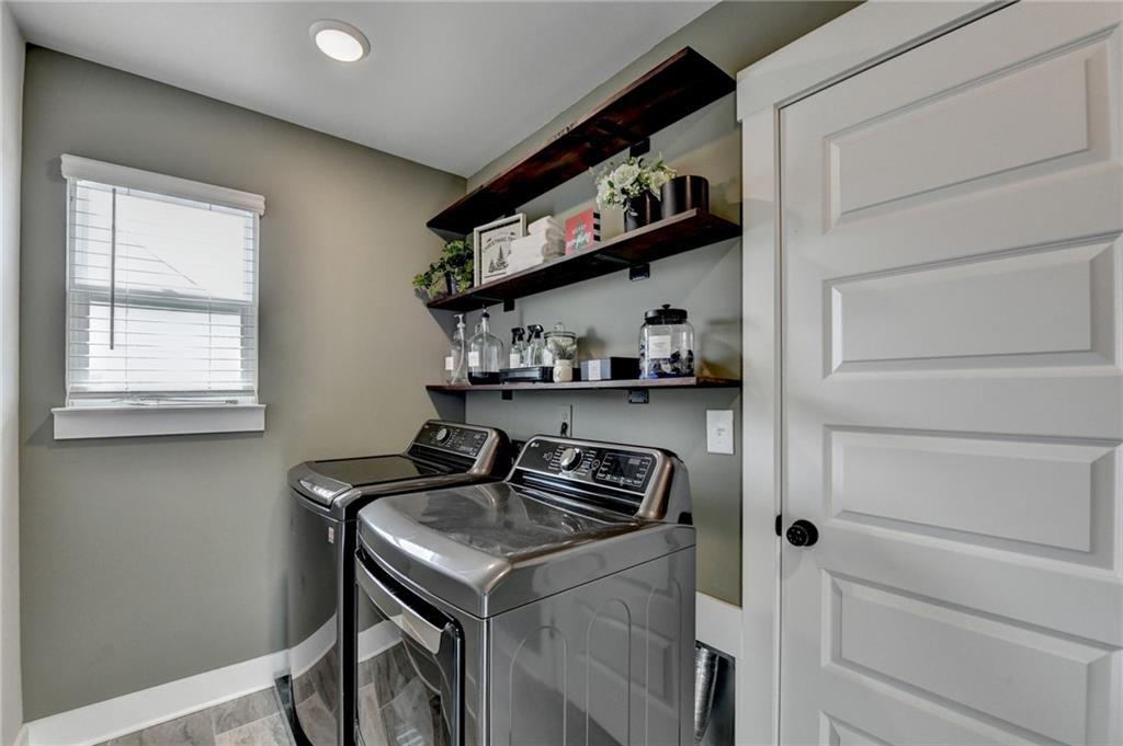 572 Redfish Way Hoschton, GA 30548 - Photo 43 of 67 a kitchen with a sink a stove and cabinets