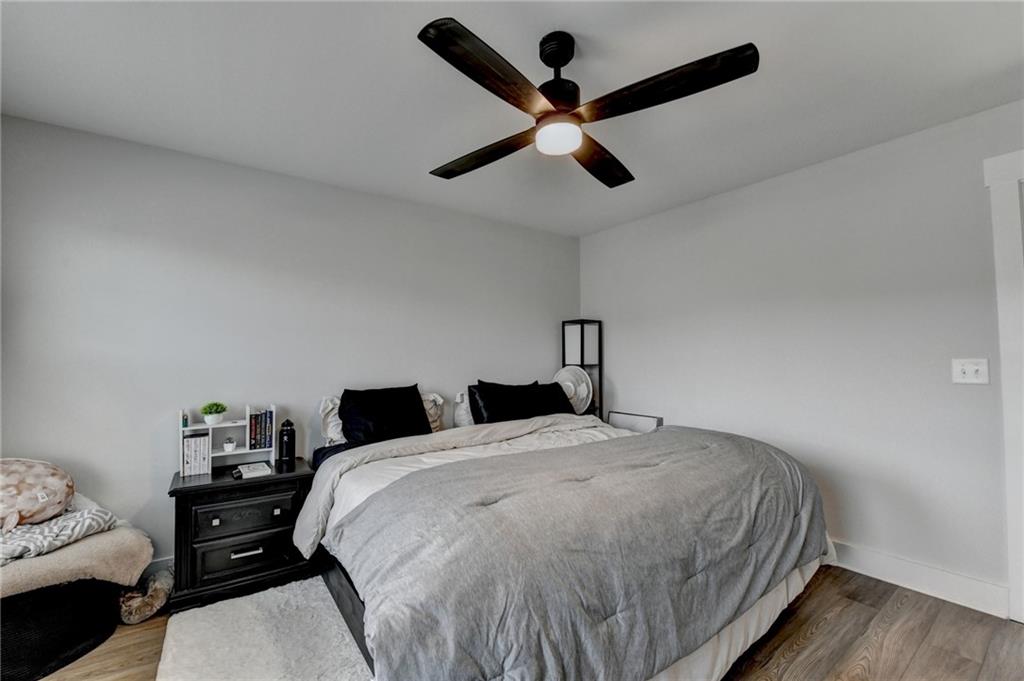 572 Redfish Way Hoschton, GA 30548 - Photo 45 of 67 a bed room with a bed and a ceiling fan