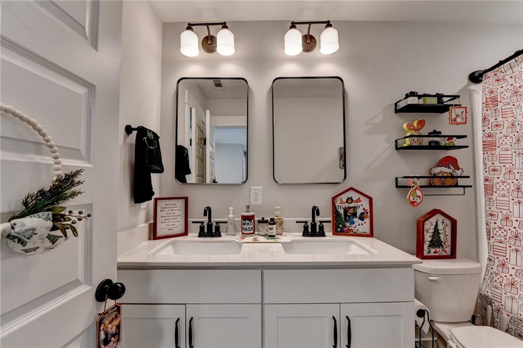 572 Redfish Way Hoschton, GA 30548 - Photo 47 of 67 a bathroom with sink and mirror