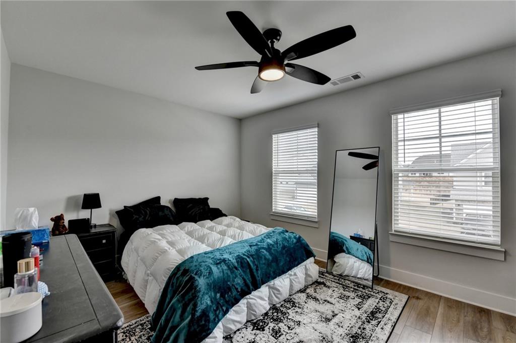 572 Redfish Way Hoschton, GA 30548 - Photo 51 of 67 a bedroom with a bed and a large window