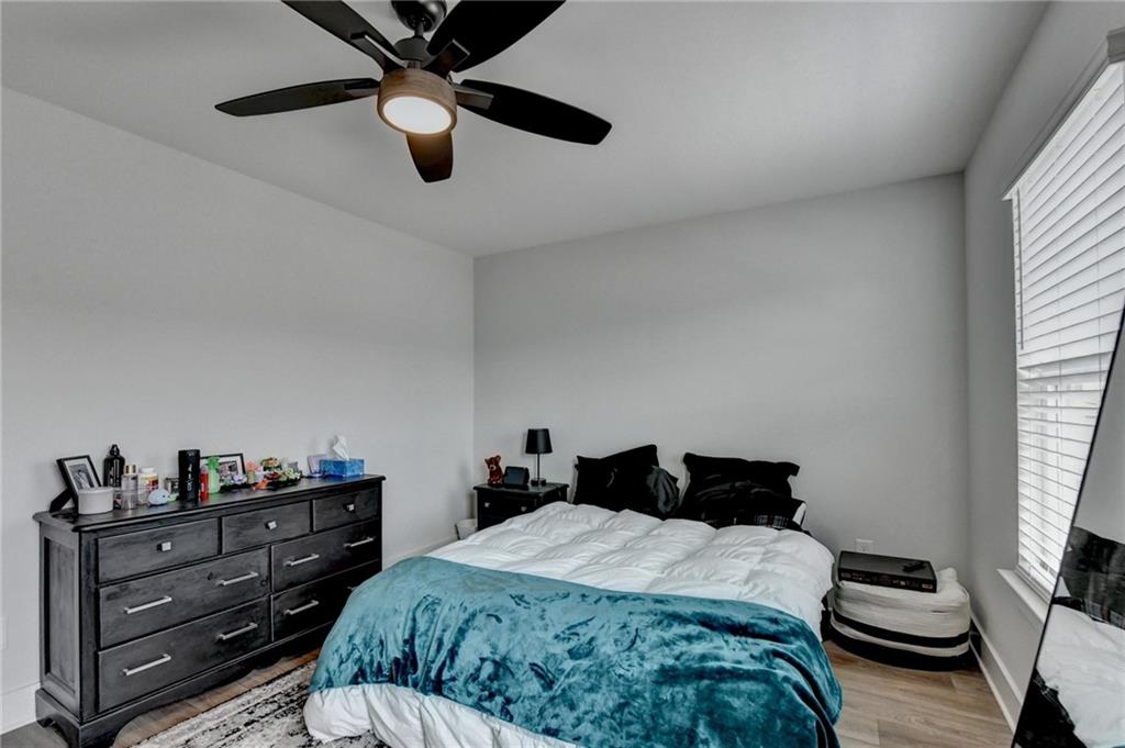 572 Redfish Way Hoschton, GA 30548 - Photo 52 of 67 a bedroom with a bed and wooden floor