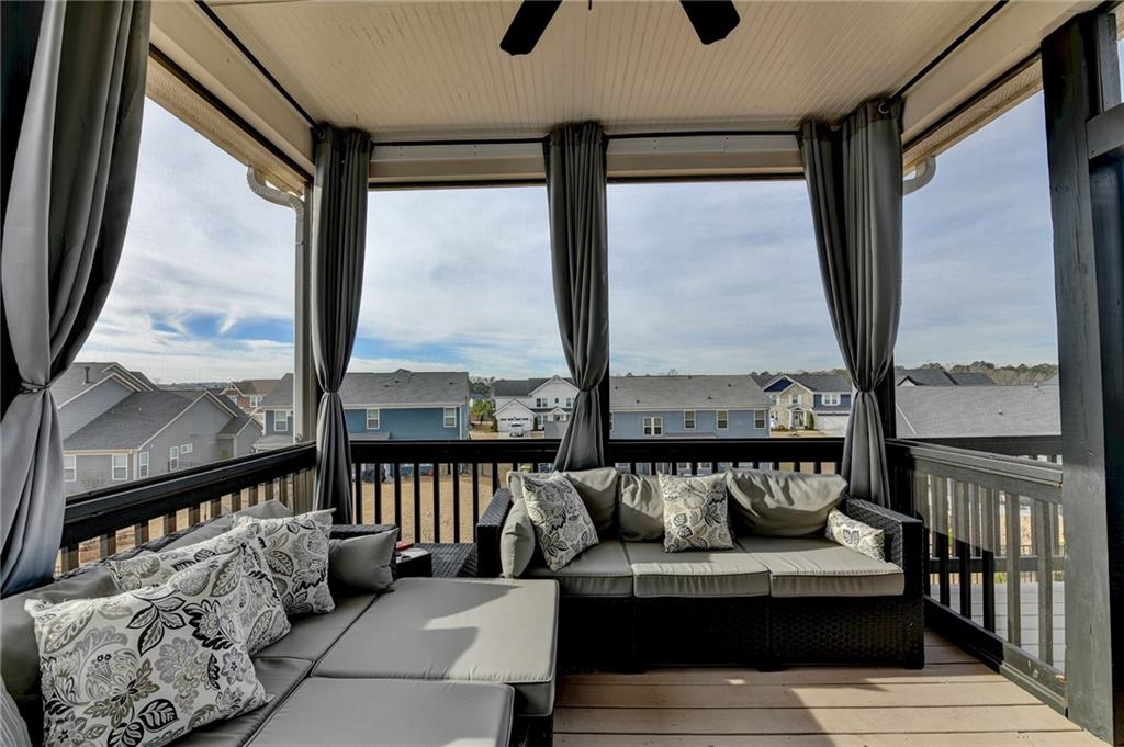 572 Redfish Way Hoschton, GA 30548 - Photo 57 of 67 a living room with furniture and a floor to ceiling window