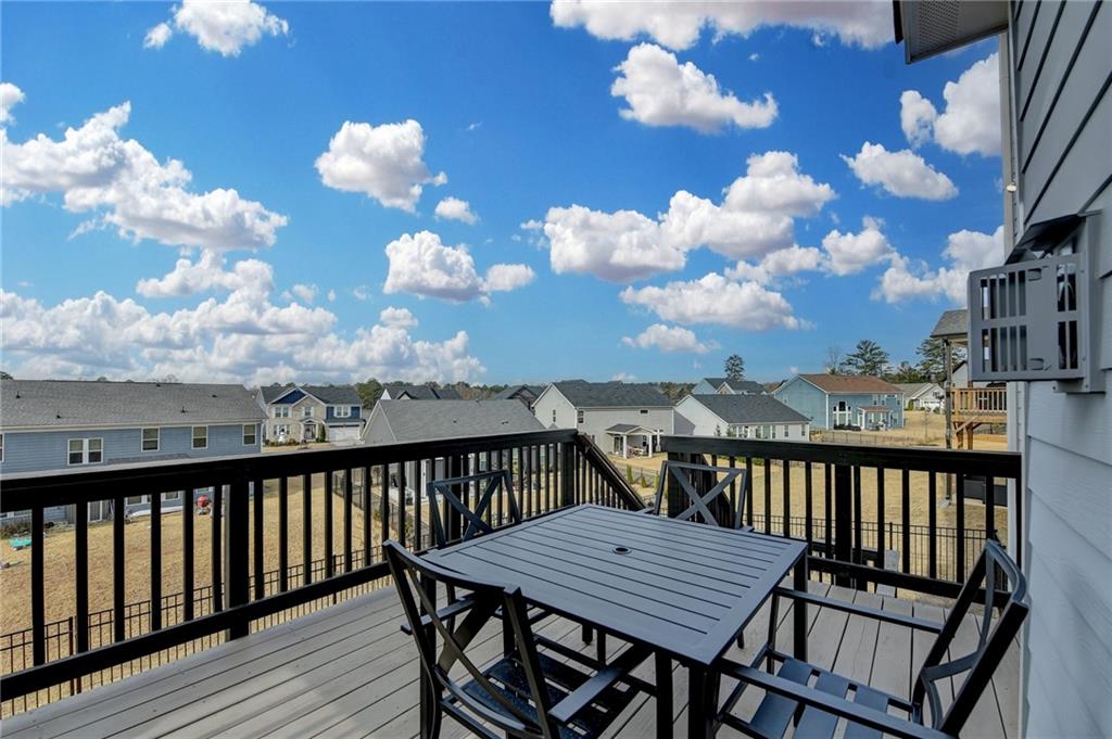 572 Redfish Way Hoschton, GA 30548 - Photo 59 of 67 a view of a balcony with wooden furniture