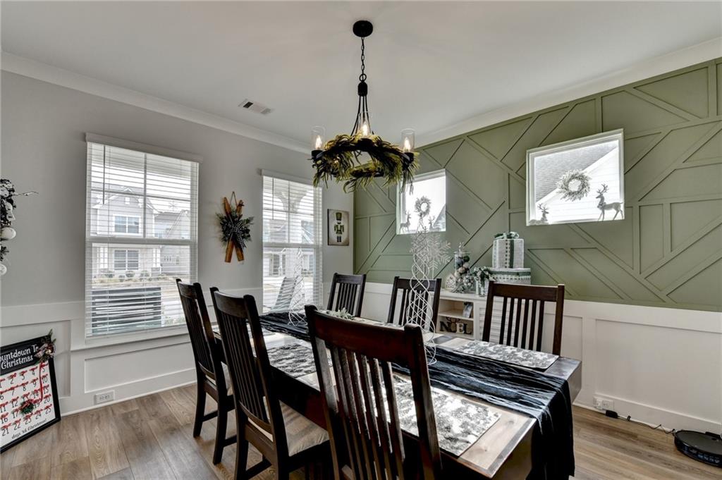 572 Redfish Way Hoschton, GA 30548 - Photo 6 of 67 a view of a dining room with furniture window and wooden floor
