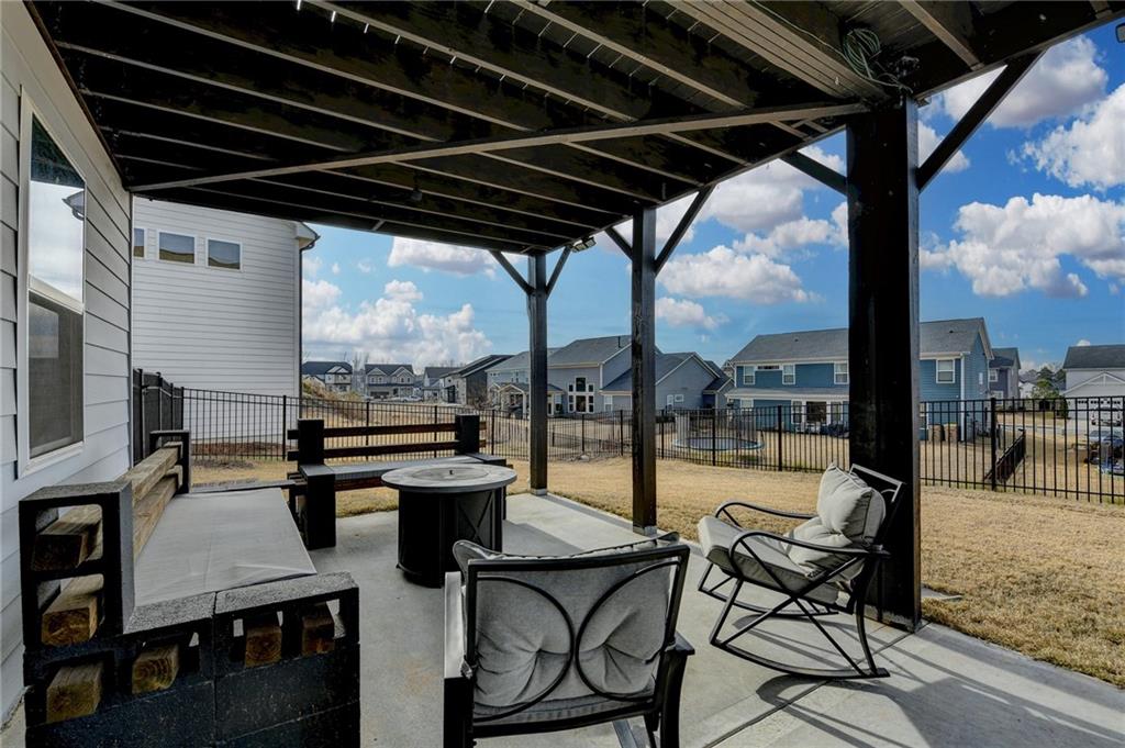572 Redfish Way Hoschton, GA 30548 - Photo 61 of 67 a view of a swimming pool with outdoor seating and plants