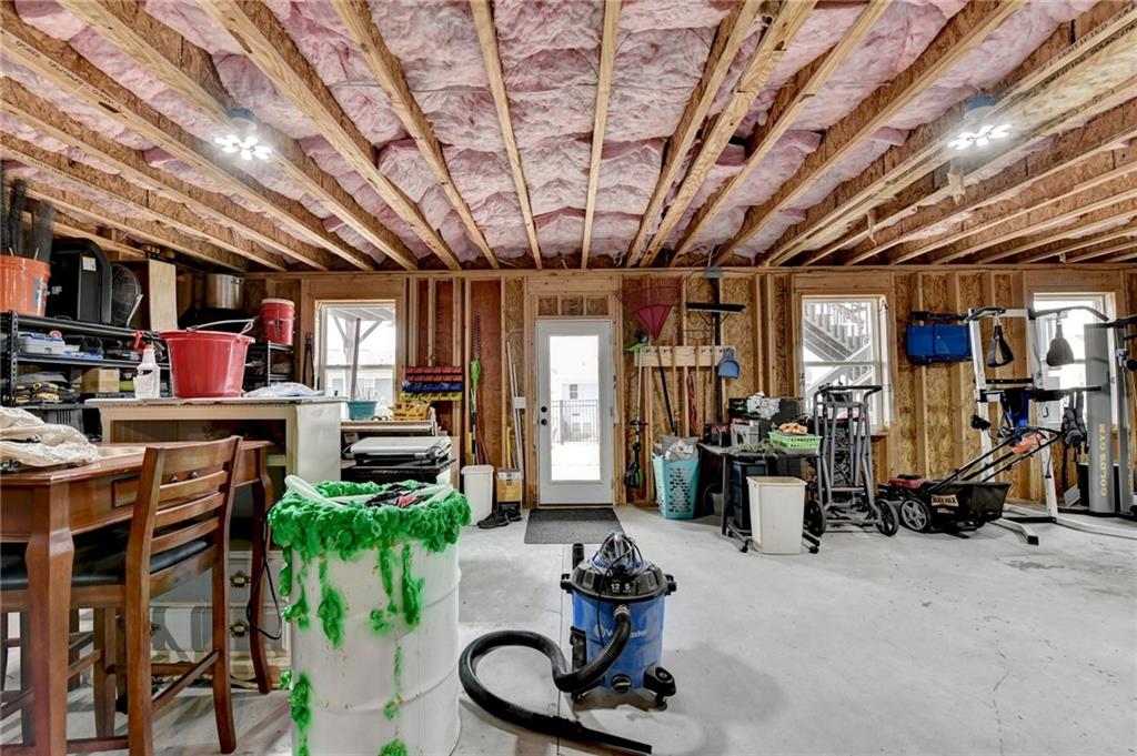 572 Redfish Way Hoschton, GA 30548 - Photo 64 of 67 a living room with furniture a flat screen tv and a large window