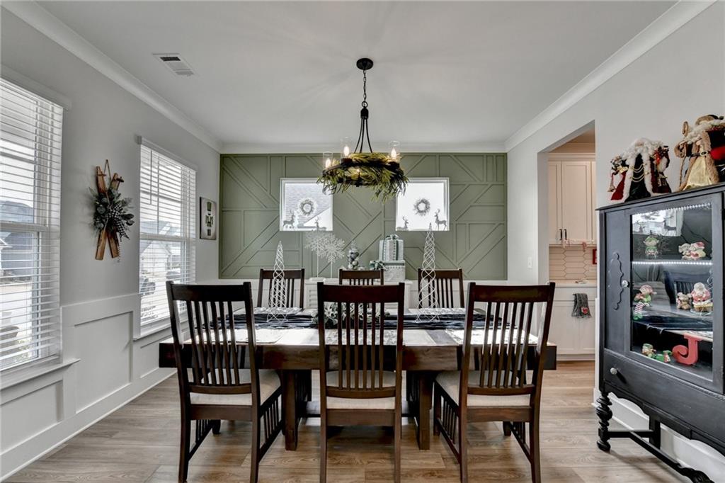 572 Redfish Way Hoschton, GA 30548 - Photo 7 of 67 a view of a dining room with furniture window and wooden floor