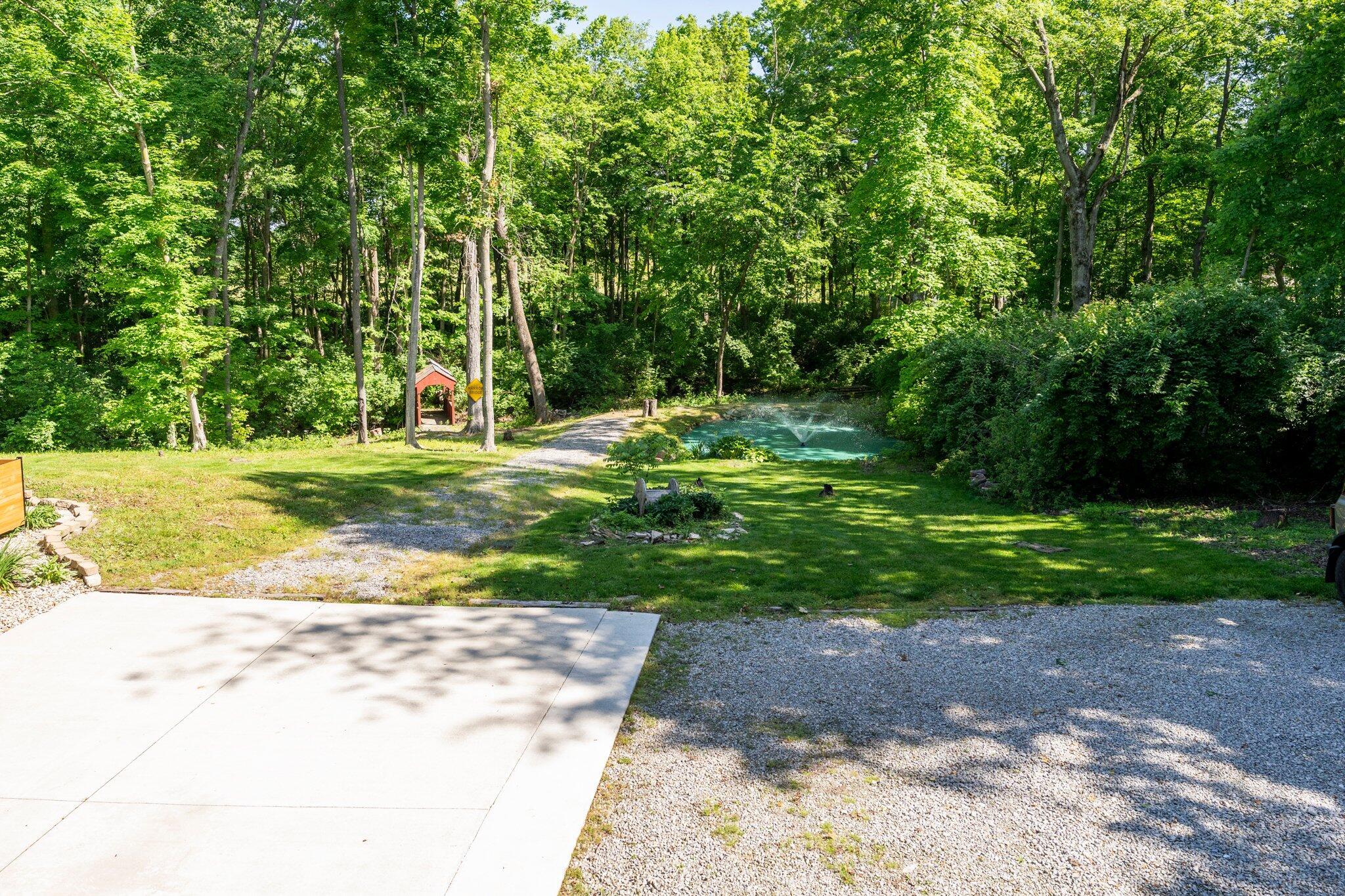 711 Ghormley Road, Unit SE Washington Court House, OH 43160 - Photo 5 of 69 Back yard trail leads to pond and bridge