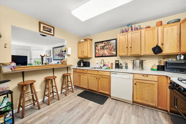 a kitchen with stainless steel appliances a sink and cabinets