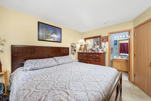 a bedroom with a large bed and a couch